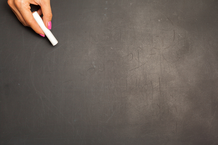 Hand holding chalk pieceの写真素材