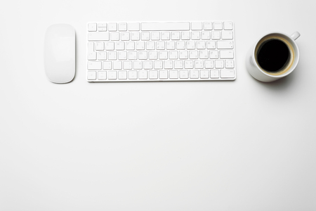 Office desk table with computer, supplies and coffee cupの写真素材