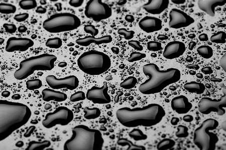 water drops splash on the black floorの写真素材