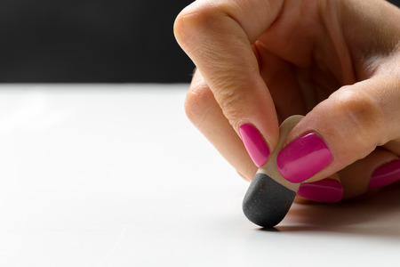 side view of hand with rubber eraserの写真素材