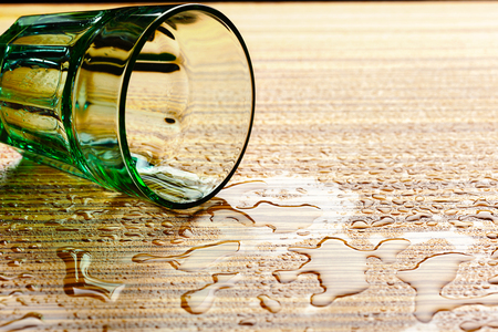 Lying down dlass and water on the tableの写真素材