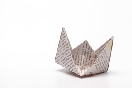 Origami paper boat isolated on white backgroundの写真素材