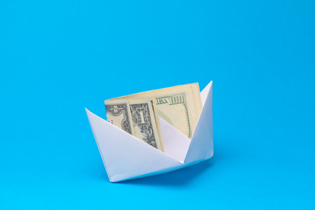 Money banknotes and paper boats. Business conceptの写真素材