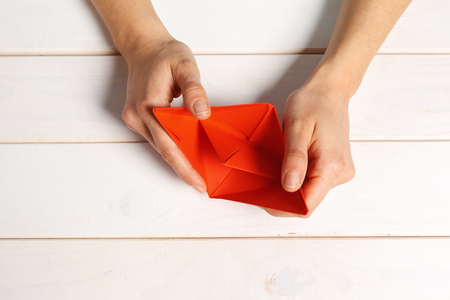 Process of handcrafting origami paper boatの写真素材