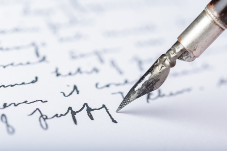 Fountain pen on an antique handwritten letterの写真素材