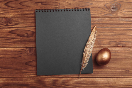 gold eggs on wooden tableの写真素材