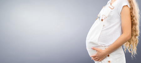 Portrait of the young happy smiling pregnant womanの写真素材