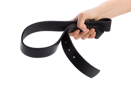 Hand holding leather belt for punishment on white backgroundの写真素材
