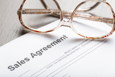 Close up shot of Eyeglasses  on contract document papers business conceptの写真素材