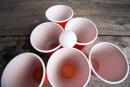 Game Beer Pong on wooden tableの写真素材