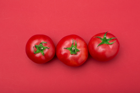 red tomatos on color backgroundの写真素材