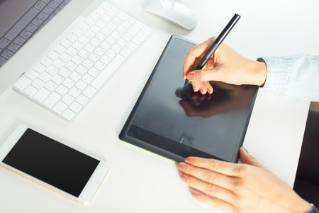 Young female designer using graphics tabletの写真素材