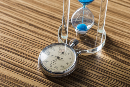 Time is passing. Blue hourglass close up