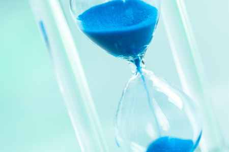 Time passing. Blue hourglass.