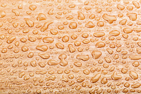 Drop of water on wooden tableの写真素材