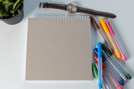 Color pencil and sketchbook on a table