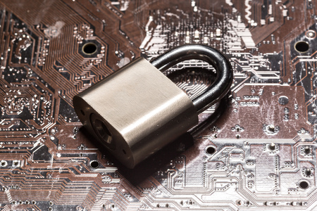 padlock on a computer circuit boardの写真素材