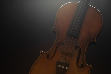 Old violin on a black background