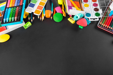 School supplies bottom border on a chalkboard background