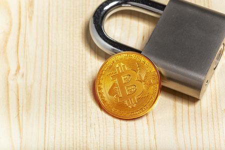 Gold bitcoin and padlock