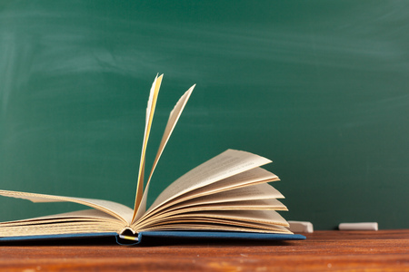 Books on Desk, Chalkboard Backgroundの写真素材