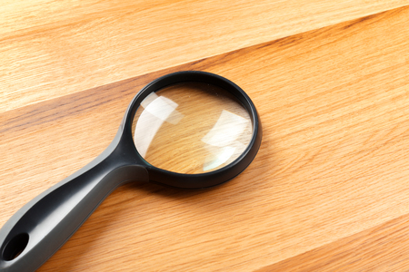magnifying glass on the wooden backgroundの写真素材