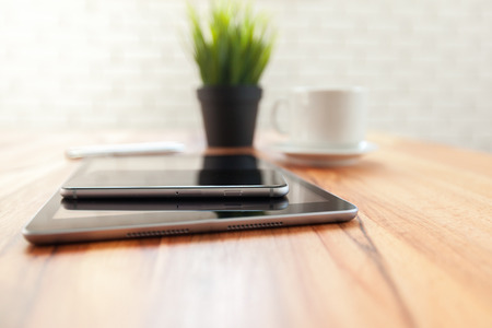 digital tablet and smart phone on wooden table