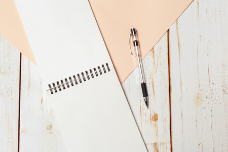 Notepad on the wooden desk tableの写真素材