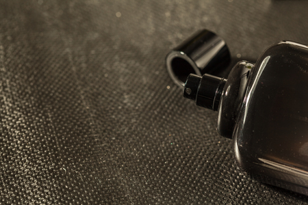 A bottle of men's perfume on a dark background.の写真素材