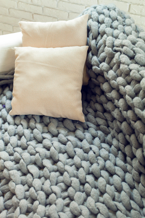 Grey knit giant plaid with pillowsの写真素材