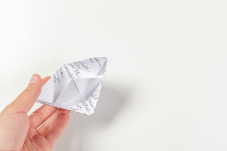 Paper ship in a female handの写真素材