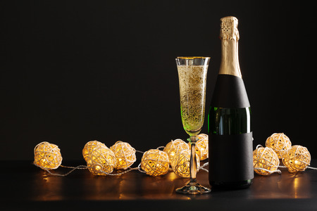 champagne wine glass and bottle on black backgroundの写真素材