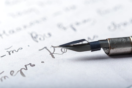 Fountain pen on an antique handwritten letter