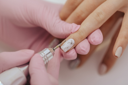 Manicurist with a milling cutter for manicureの写真素材