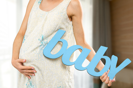 Portrait of the young happy smiling pregnant womanの写真素材