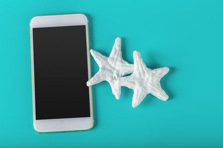 Mobile phone and starfishの写真素材
