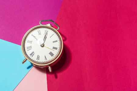 Vintage metal clock on colorful backgroundの写真素材
