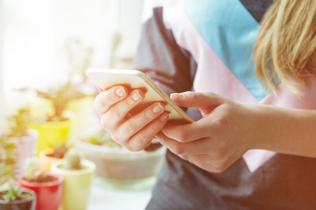 Woman typing write message on smart phoneの写真素材