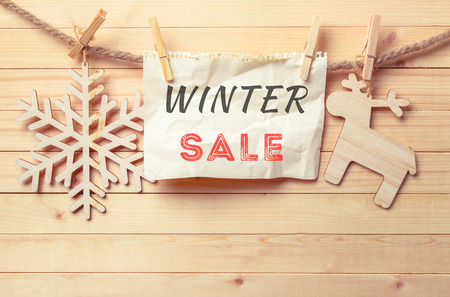 clothespin hanging with blank paper on wooden backgroundの写真素材