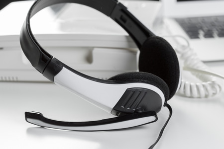 call center support concept. headset on keyboard computer laptopの写真素材