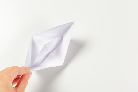 Paper ship in a female handの写真素材