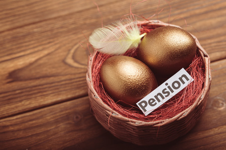gold eggs on wooden tableの写真素材