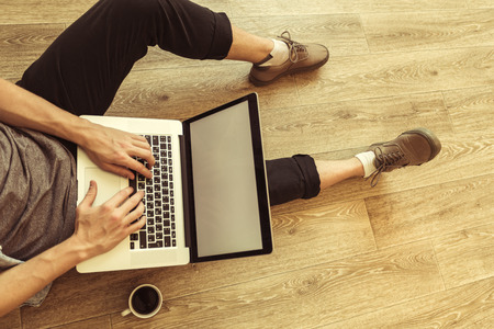young student works on his laptop at homeの写真素材