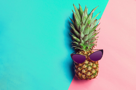 pineapple on colored paper with glasses