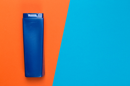 Cosmetic product on a bright bicolor background, top view