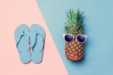 pineapple on colored paper with glassesの写真素材