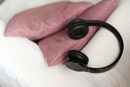 headphone lying on pillow for listening relax musicの写真素材