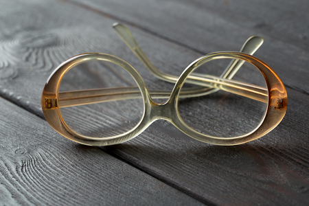eyeglasses on wooden tableの写真素材