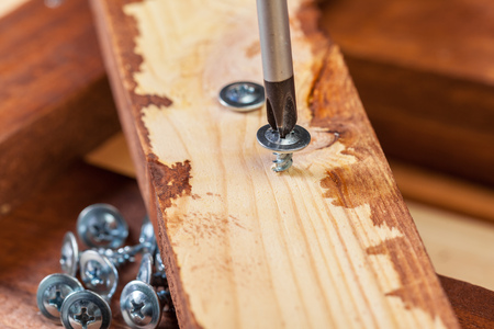 screw screwed into a wooden bar