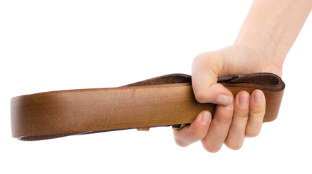 Hand holding leather belt for punishment on white backgroundの写真素材